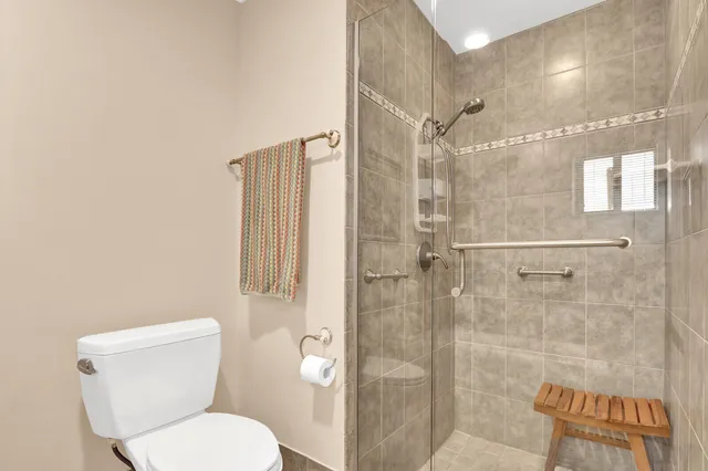 a bathroom with a toilet and a shower