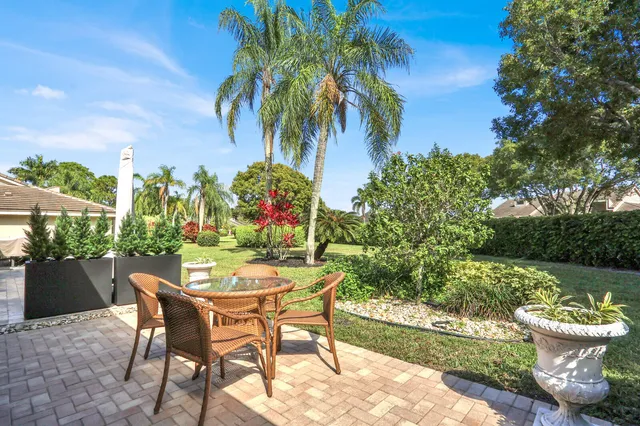 a view of a chairs and table in the backyard
