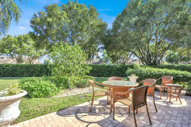 a view of a chair and table on the garden