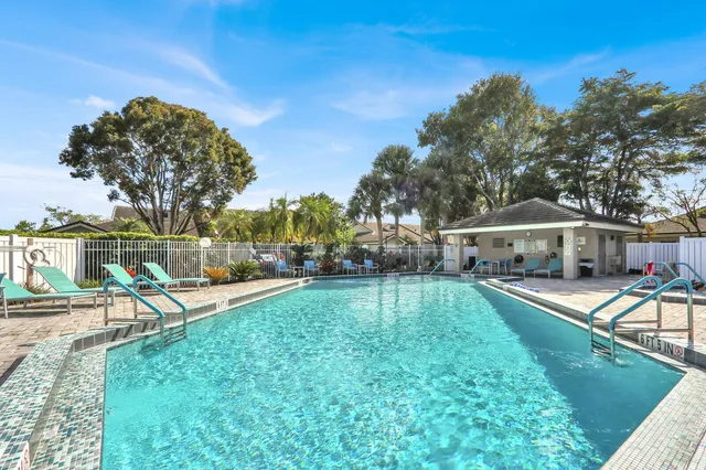 a view of a house with swimming pool and sitting area