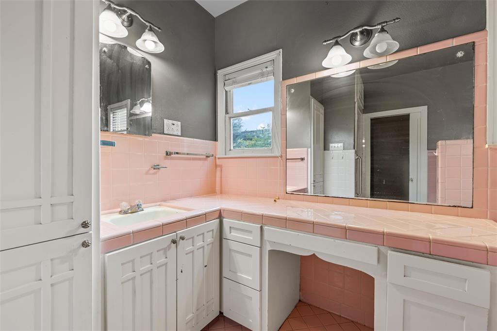 2717 Colcord Avenue Waco, TX 76707 - Photo 18 of 34 a bathroom with a sink a vanity and a mirror