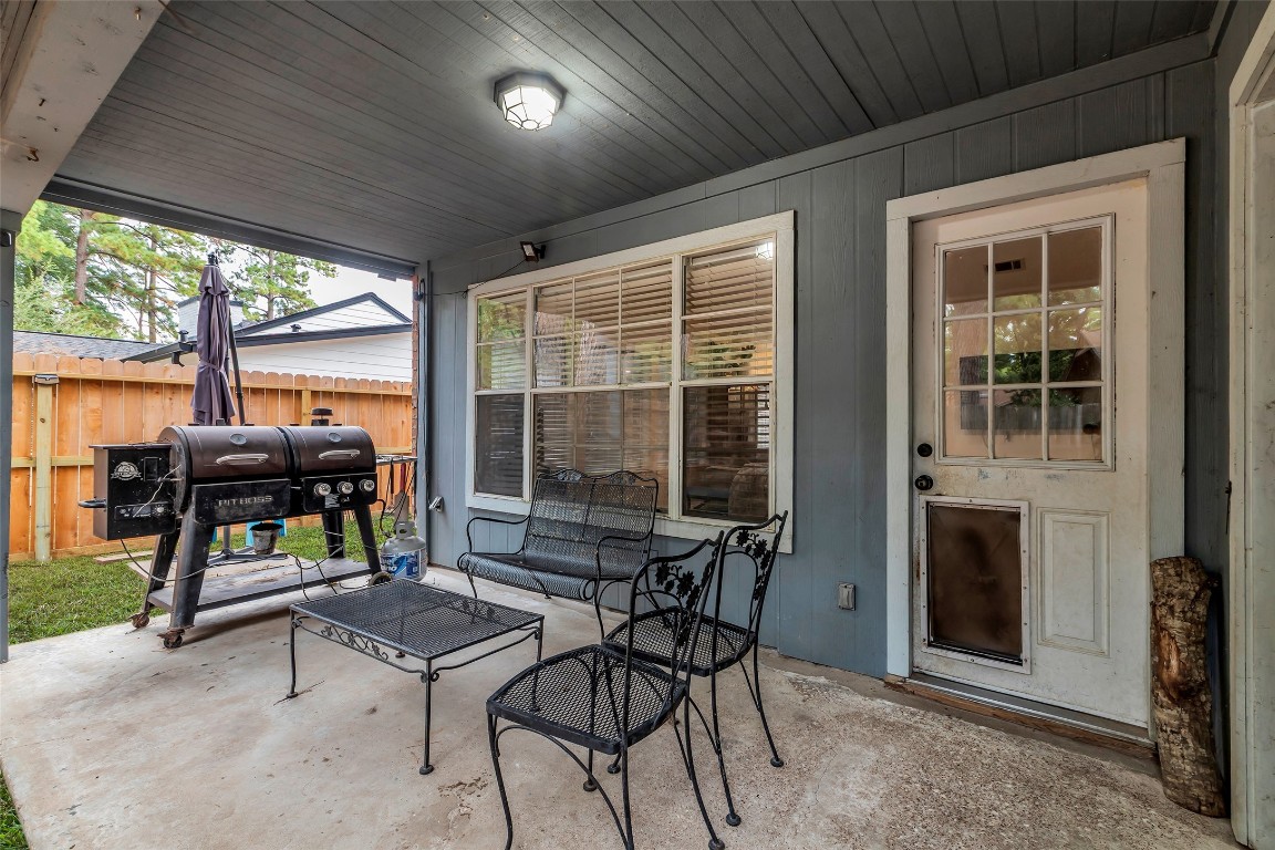 13860 Ventura Road Willis, TX 77318 - Photo 17 of 22 a outdoor space with patio the couches and a dining table with garden view