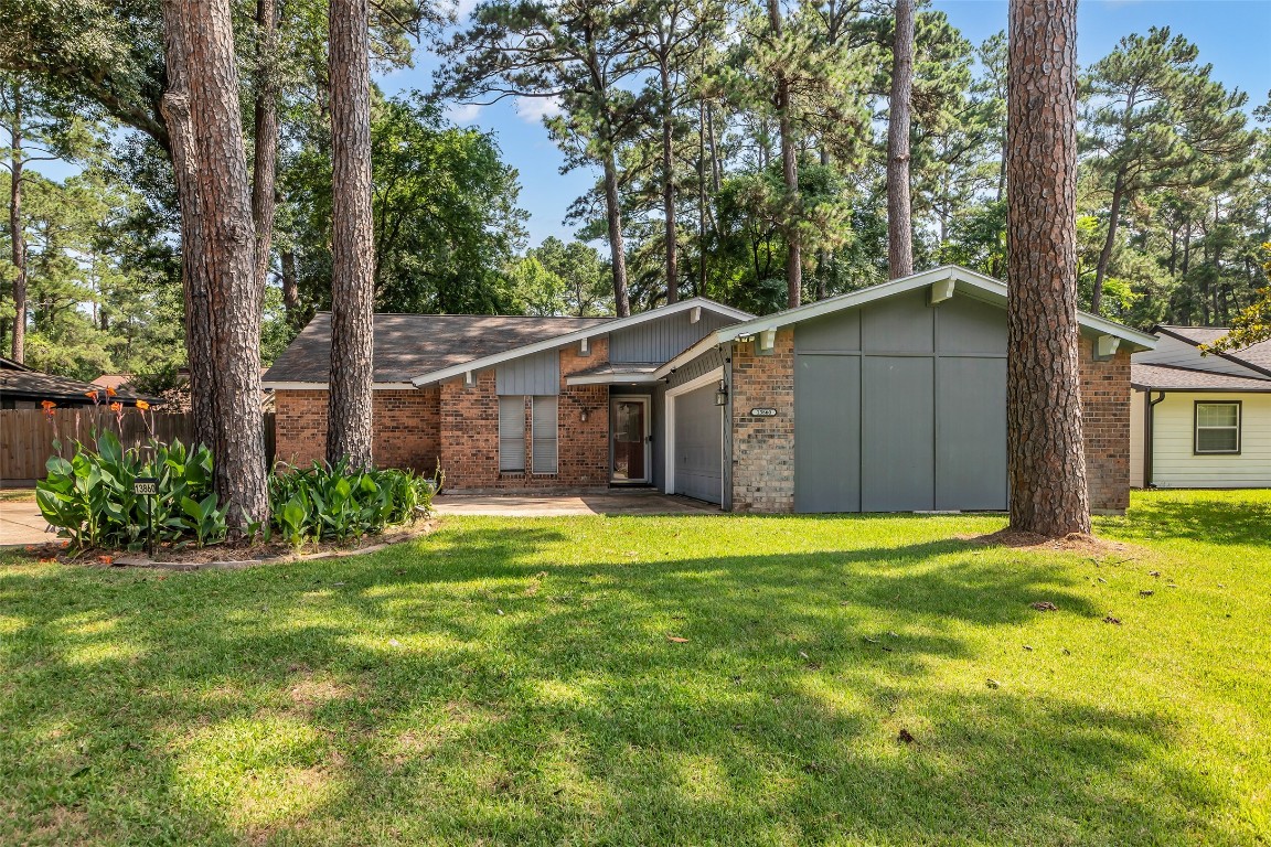 13860 Ventura Road Willis, TX 77318 - Photo 2 of 22 a front view of a house with a yard
