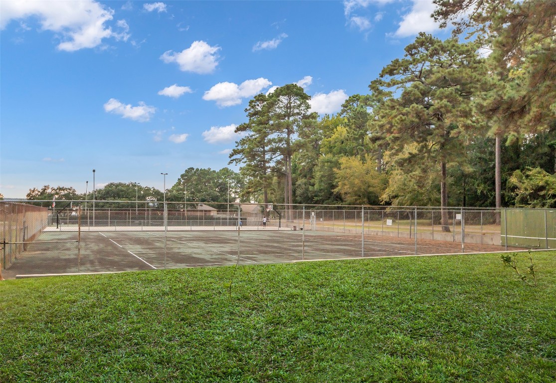 13860 Ventura Road Willis, TX 77318 - Photo 22 of 22 a backyard of a house with lots of green space and lake view