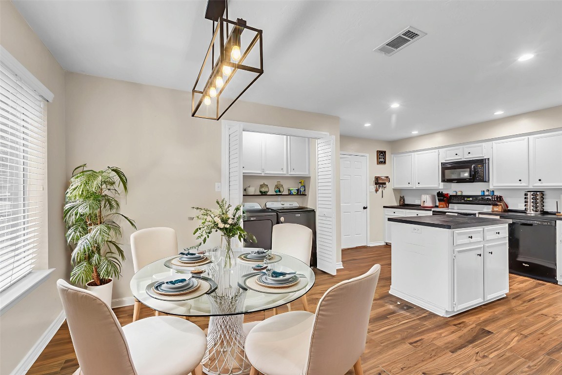 13860 Ventura Road Willis, TX 77318 - Photo 7 of 22 a kitchen with stainless steel appliances kitchen island granite countertop a kitchen island hardwood floor and living room view