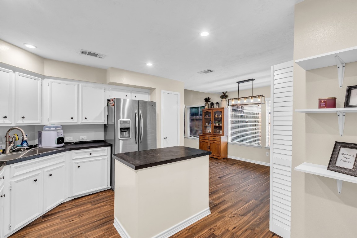13860 Ventura Road Willis, TX 77318 - Photo 9 of 22 a kitchen with stainless steel appliances a refrigerator sink and cabinets