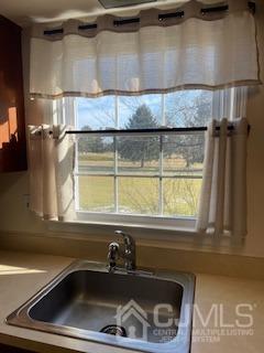 a bathroom with a sink and a window