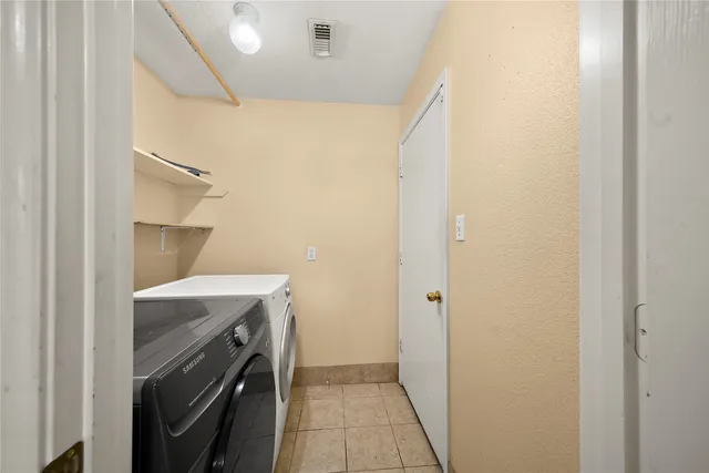 a utility room with a sink dryer and washer