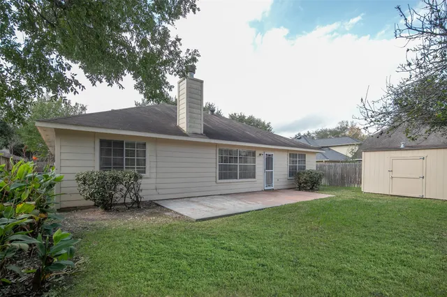 a backyard of a house with table and chairs