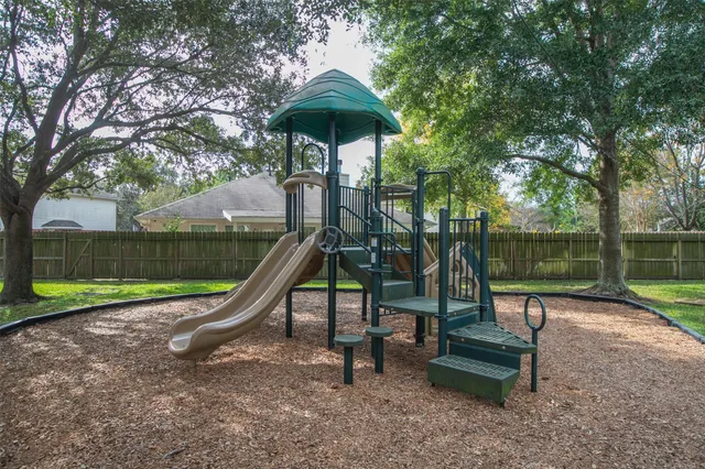 a park with a bench and trees