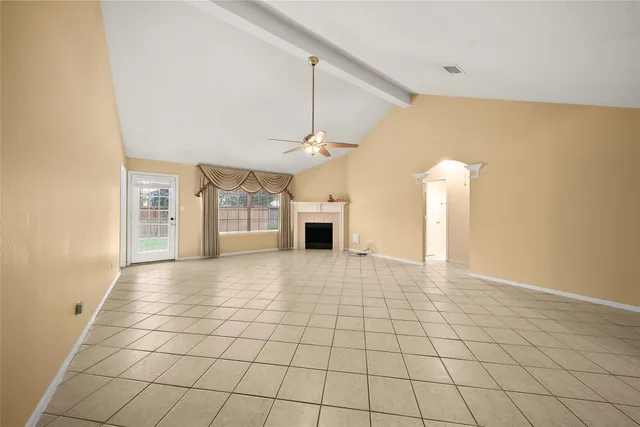 a view of a livingroom with an empty space and a fireplace