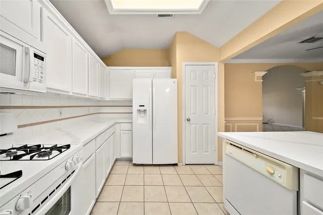 a kitchen with a stove a sink and a refrigerator
