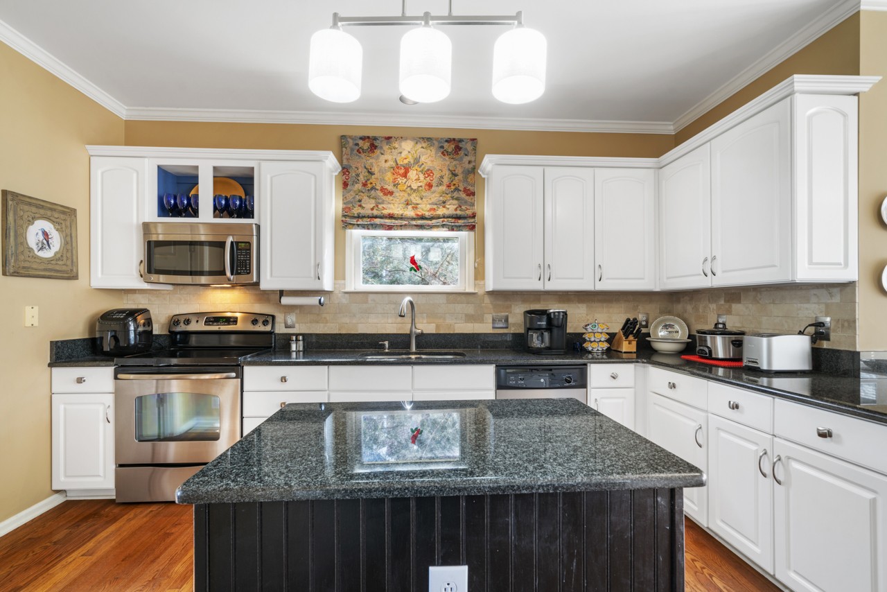 114 Rigby Drive Franklin, TN 37064 - Photo 18 of 55 a kitchen with stainless steel appliances granite countertop a stove a sink and a microwave