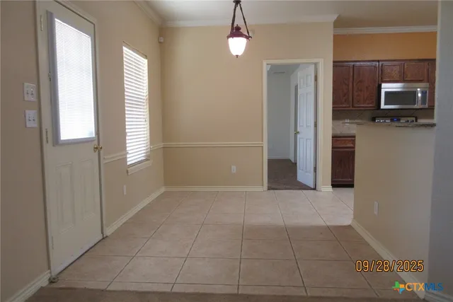 a view of a hallway with wooden floor and a fireplace