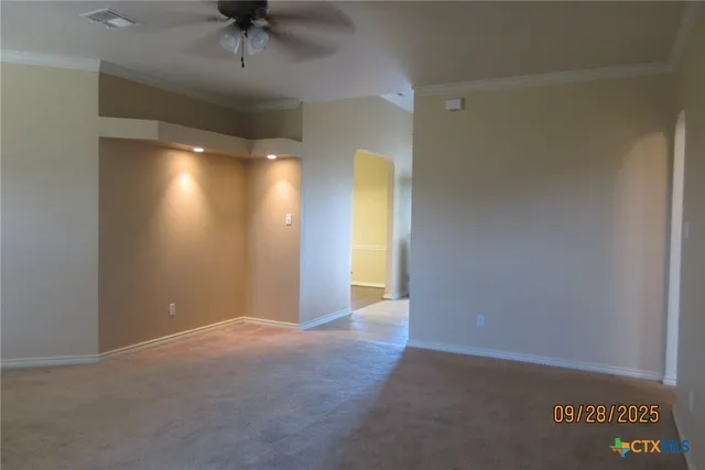 an empty room with a fireplace and windows