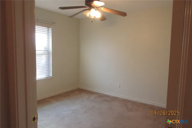 a view of a hallway with wooden floor and a door