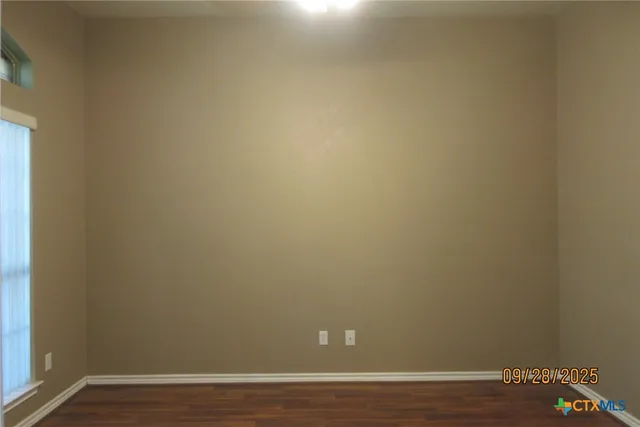 a view of a room with wooden floor and white walls