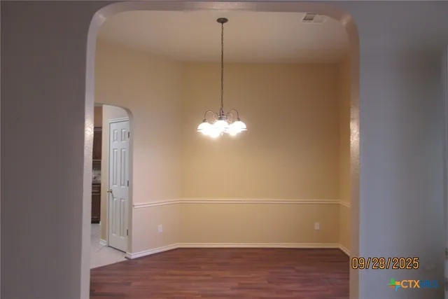 a room with a wooden floor and a ceiling fan
