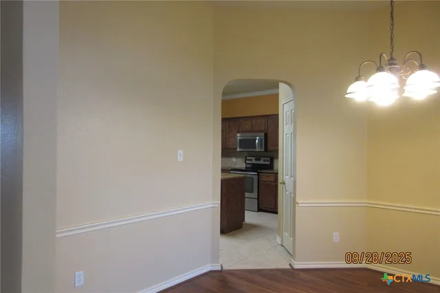a view of a room with wooden floor