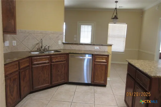 a kitchen with a sink and a refrigerator