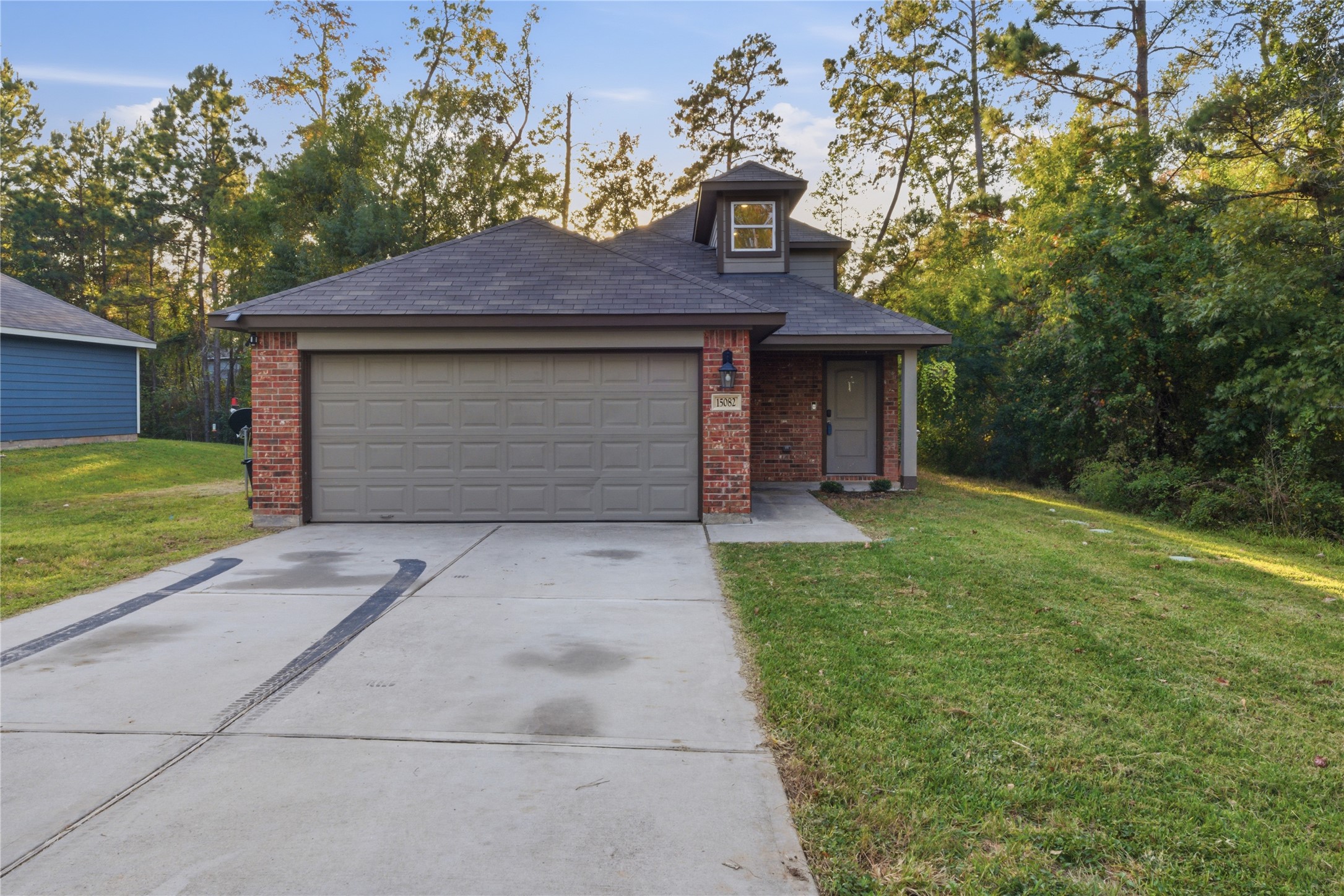 a front view of a house with a yard and garage