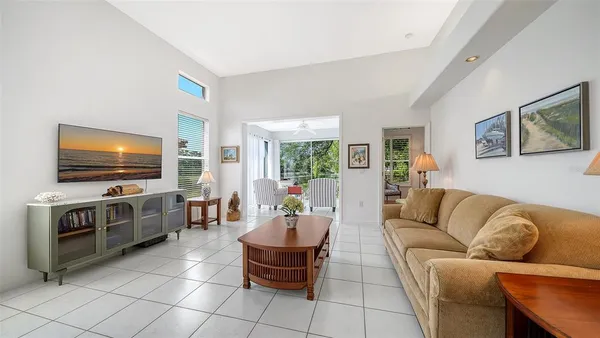 a living room with furniture and a large mirror