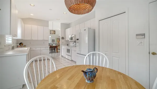 a dining room with furniture a livingroom view and a large window
