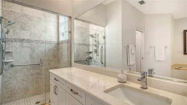 a bathroom with a sink a vanity and a mirror