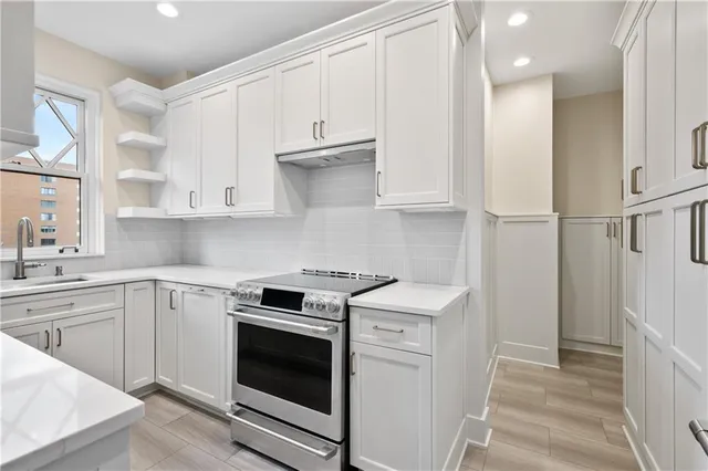 a kitchen with white cabinets and white appliances