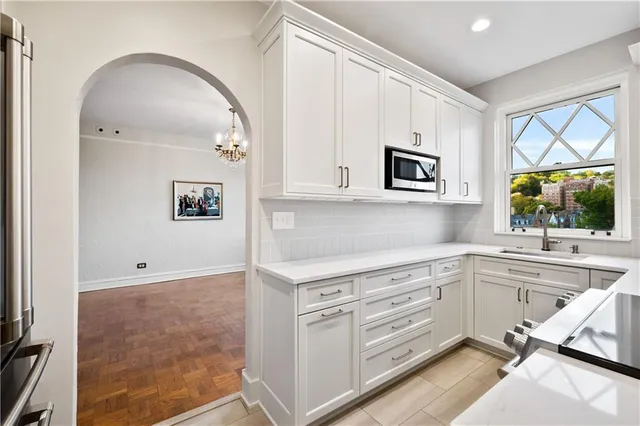 a kitchen with granite countertop white cabinets and white appliances