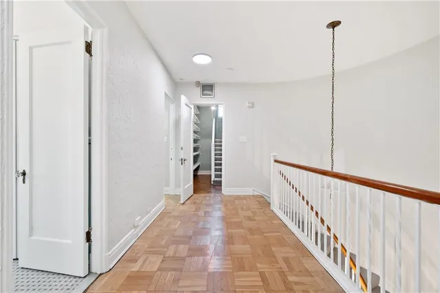 a view of a hallway with wooden floor