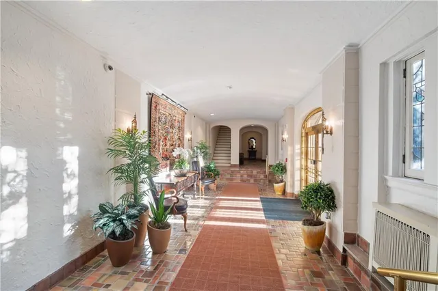 a living room with furniture and a potted plant