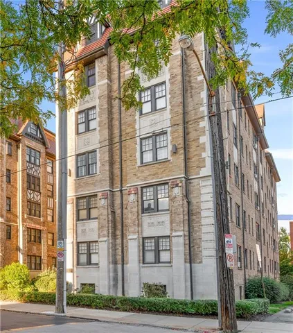 a view of a brick building next to a road