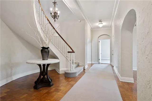 a view of entryway and hall with wooden floor
