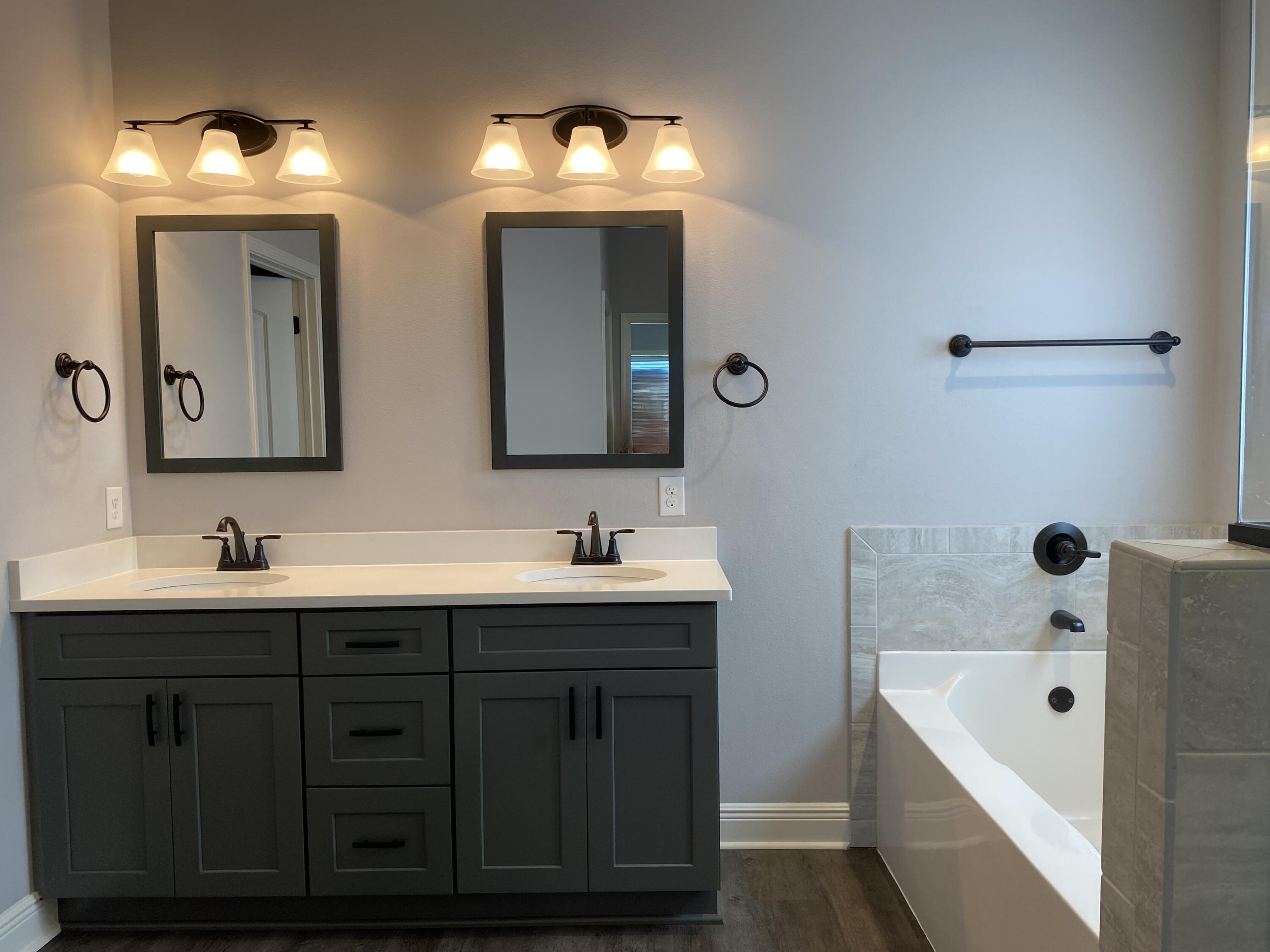 3909 Fielding Court Pace, FL 32571 - Photo 12 of 25 a bathroom with a double vanity sink mirror double and bathtub