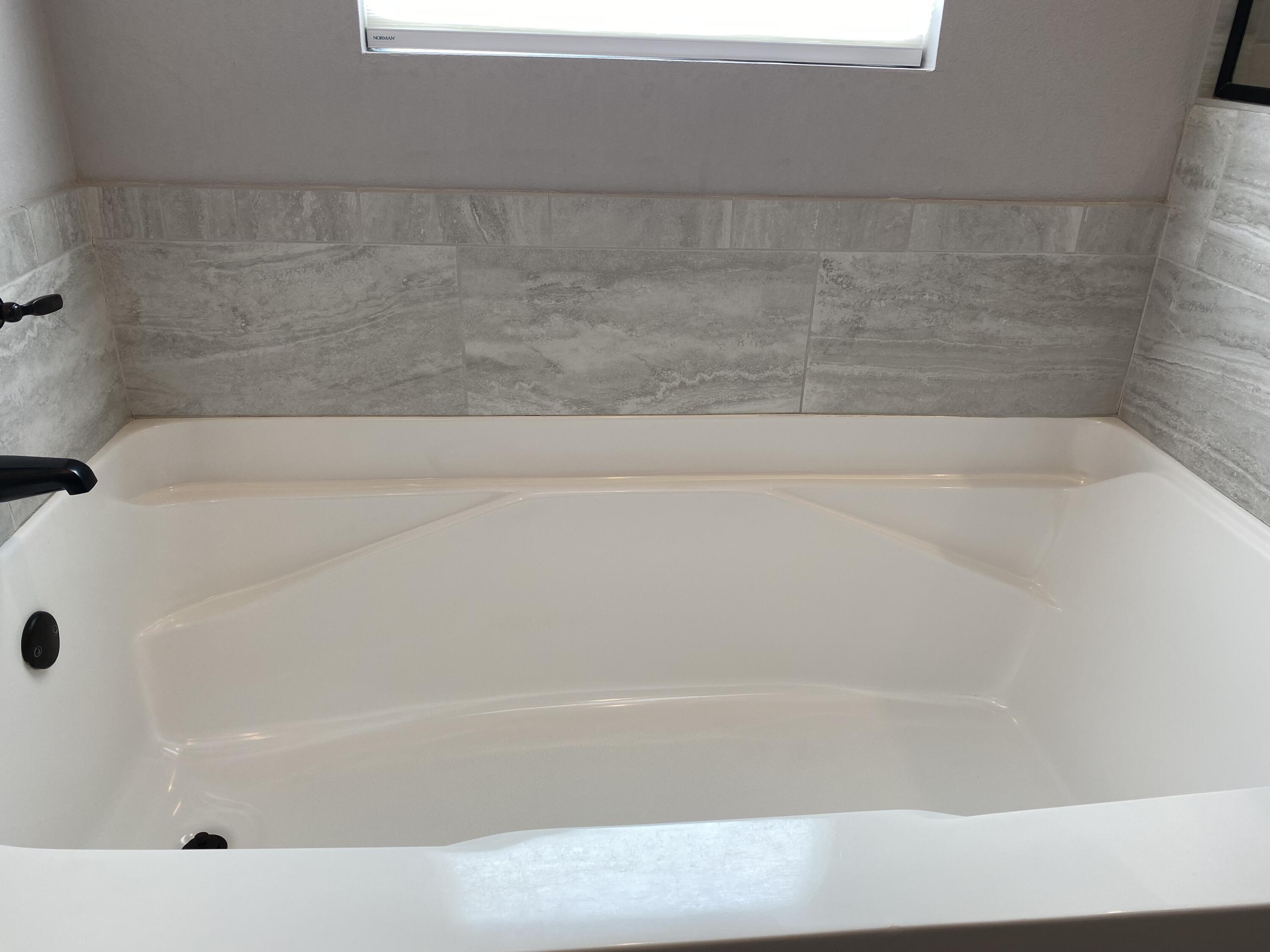 3909 Fielding Court Pace, FL 32571 - Photo 13 of 25 a bathroom with a bathtub