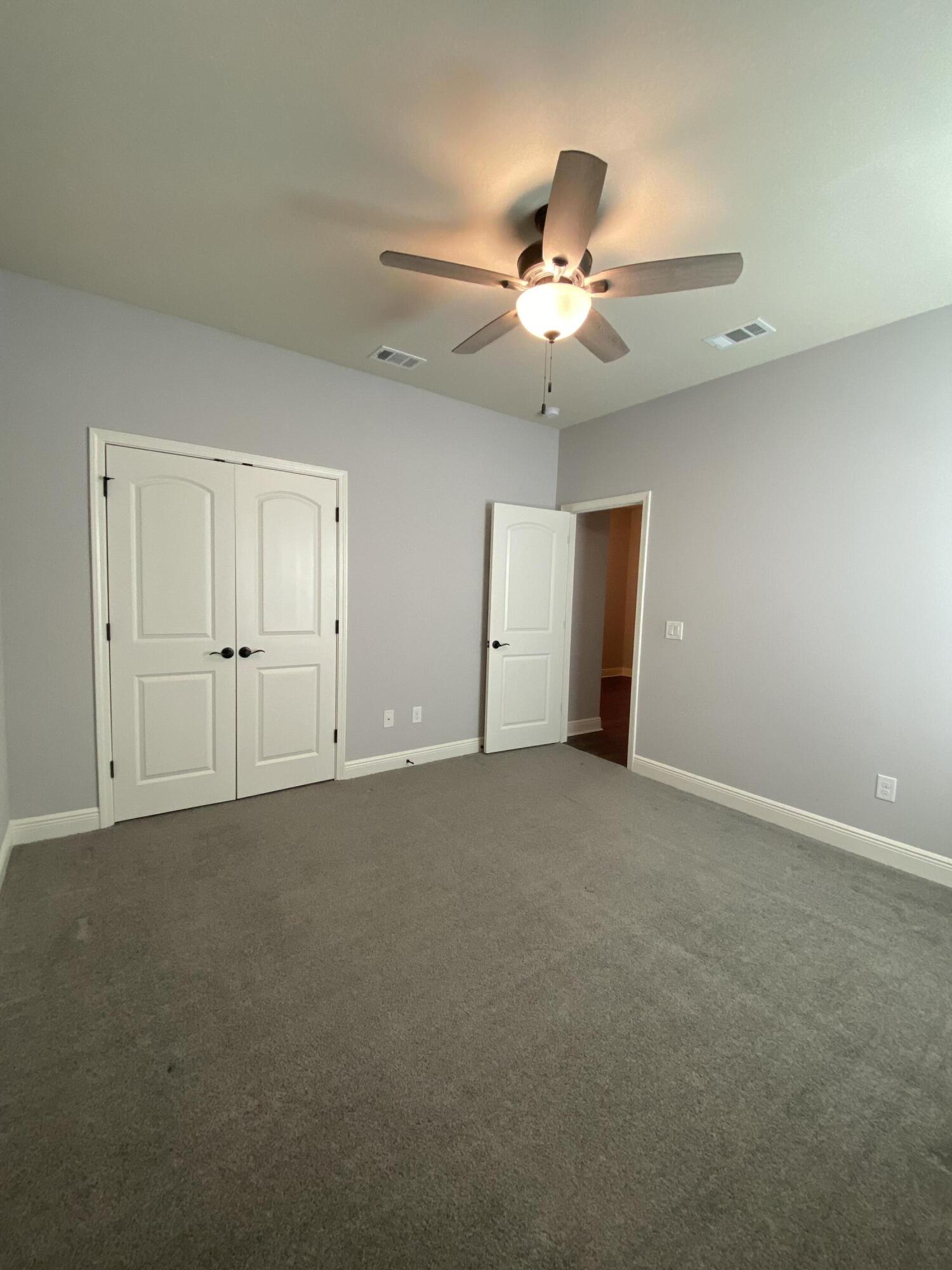 3909 Fielding Court Pace, FL 32571 - Photo 16 of 25 an empty room with closet and a ceiling fan