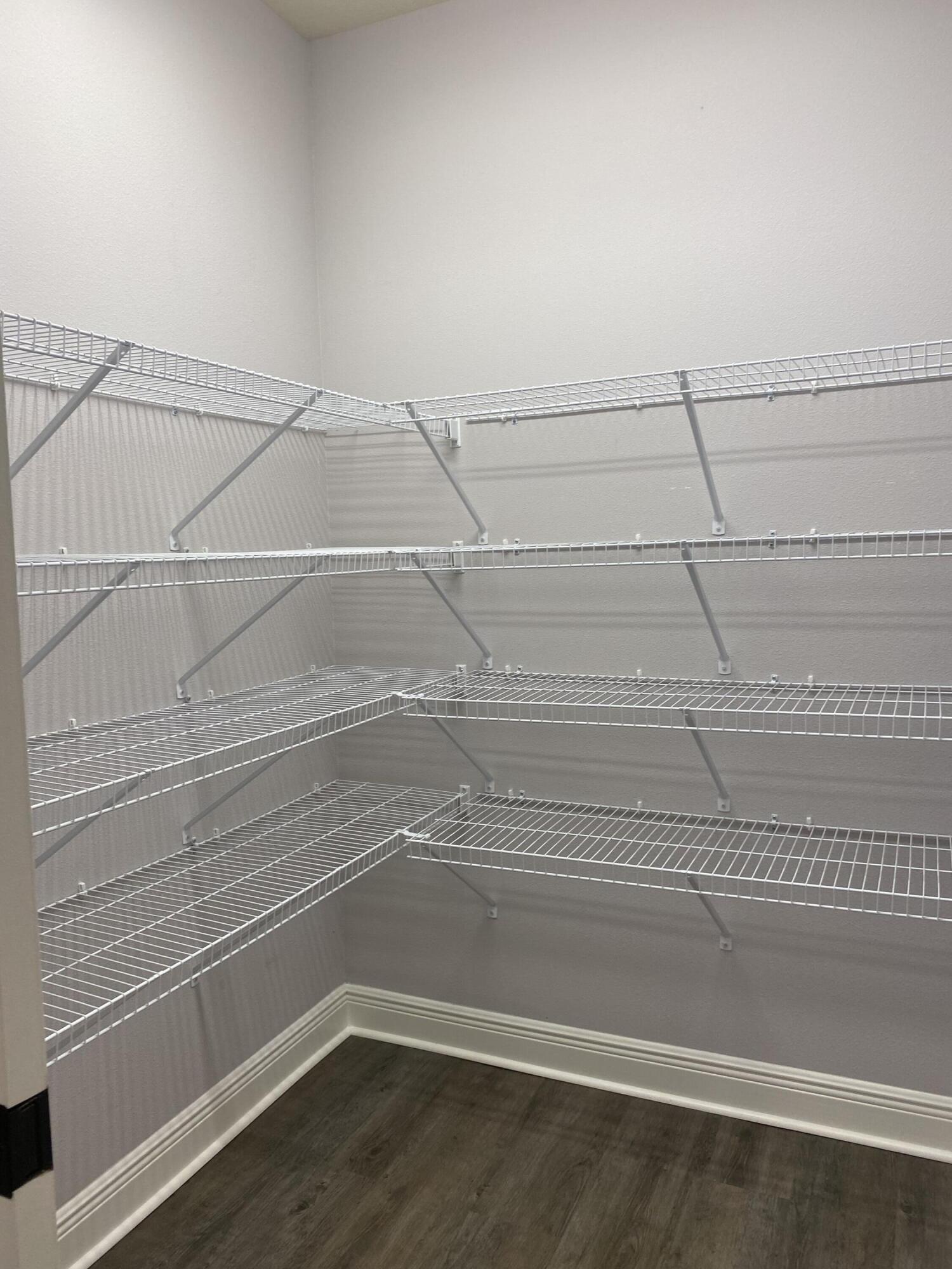 3909 Fielding Court Pace, FL 32571 - Photo 17 of 25 a view of a room with racks on the wall