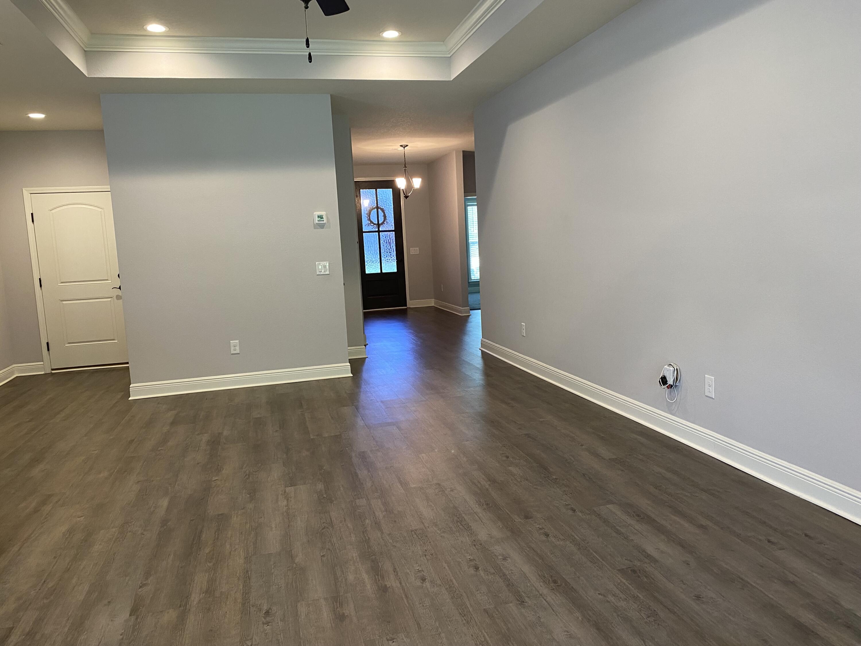 3909 Fielding Court Pace, FL 32571 - Photo 3 of 25 an empty room with wooden floor and windows