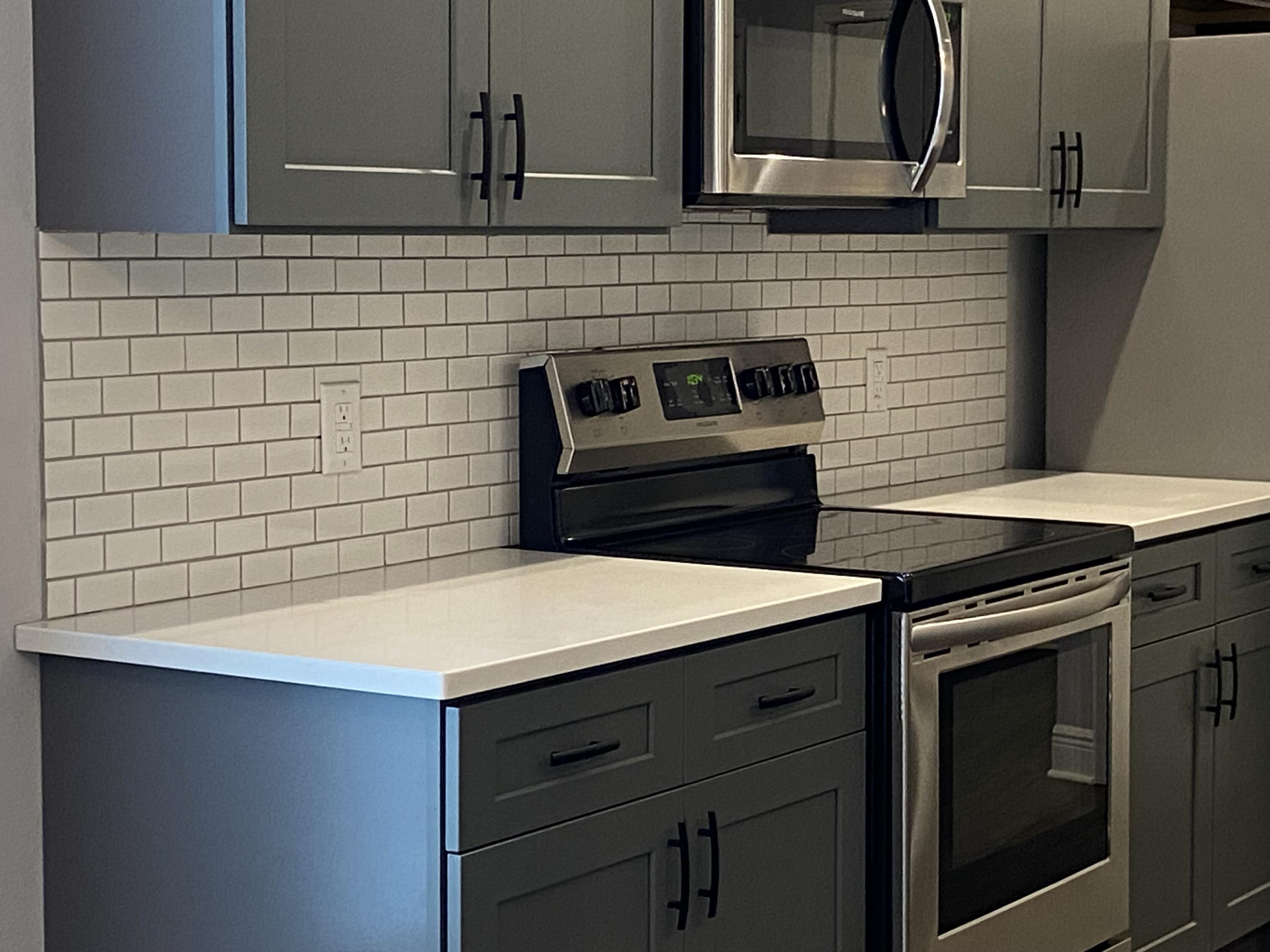3909 Fielding Court Pace, FL 32571 - Photo 7 of 25 a kitchen with a stove cabinets and wooden floor