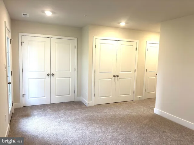 an empty room with closet area