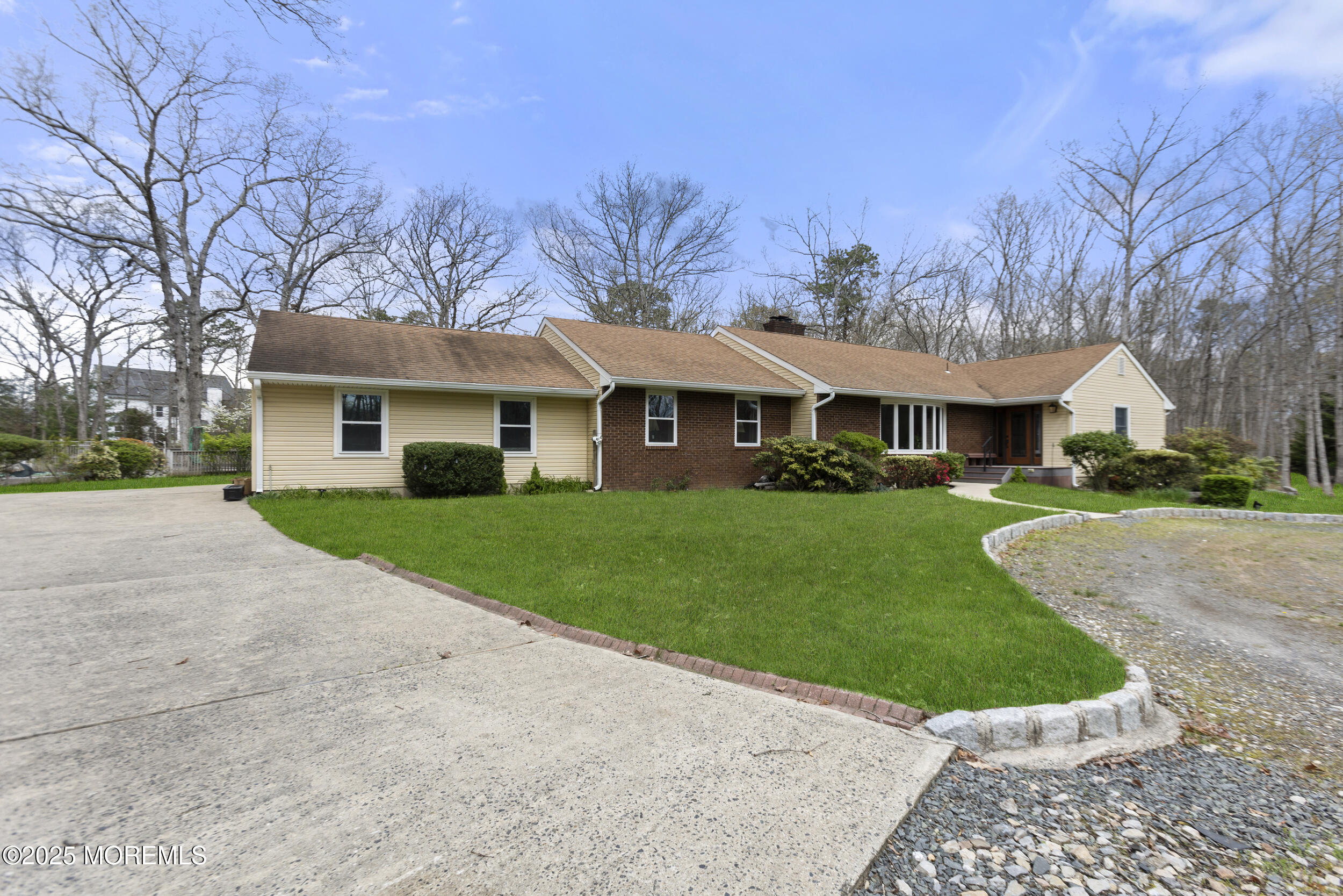 a front view of house with yard and green space