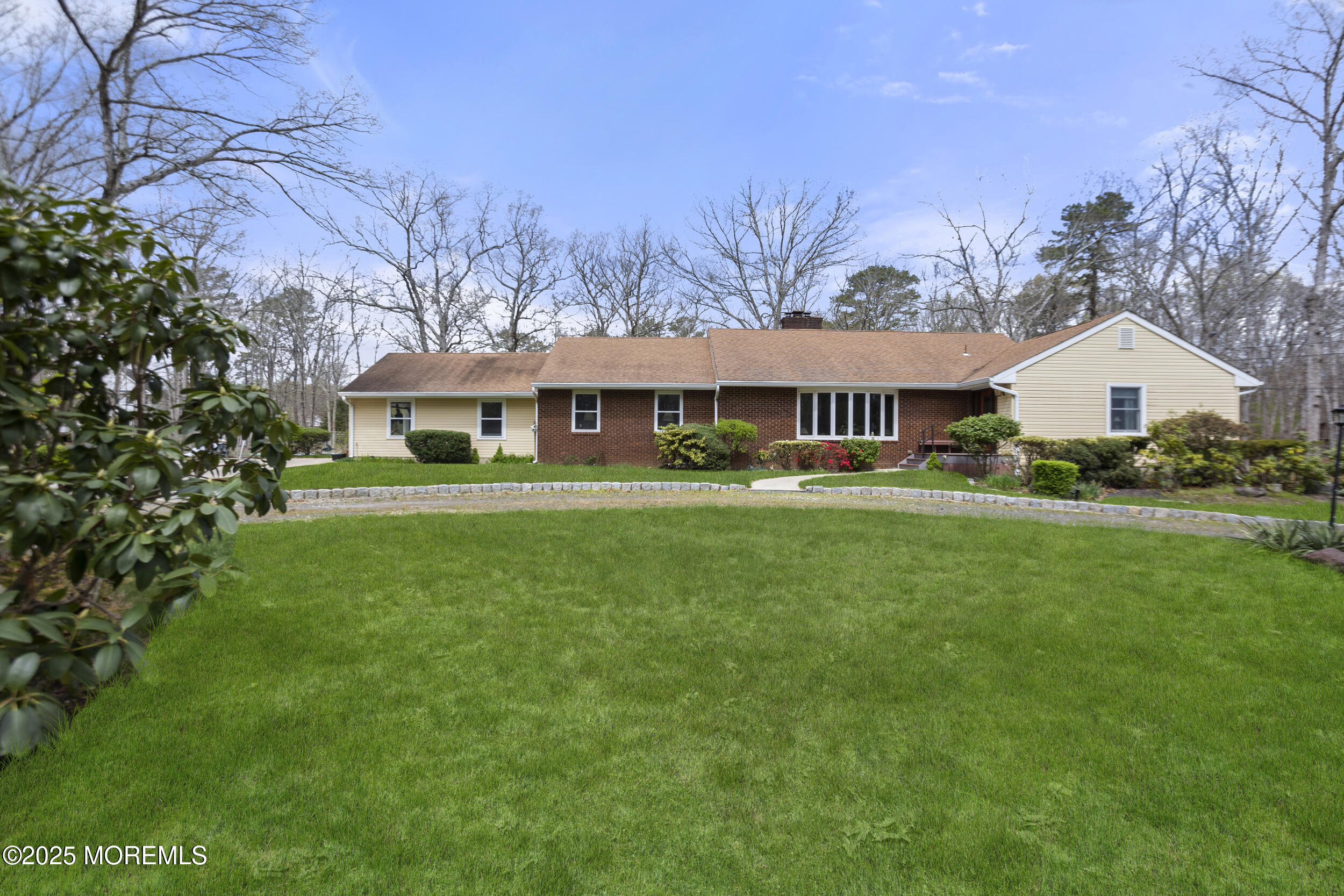 156 Sams Road Jackson, NJ 08527 - Photo 3 of 46 a front view of a house with a garden