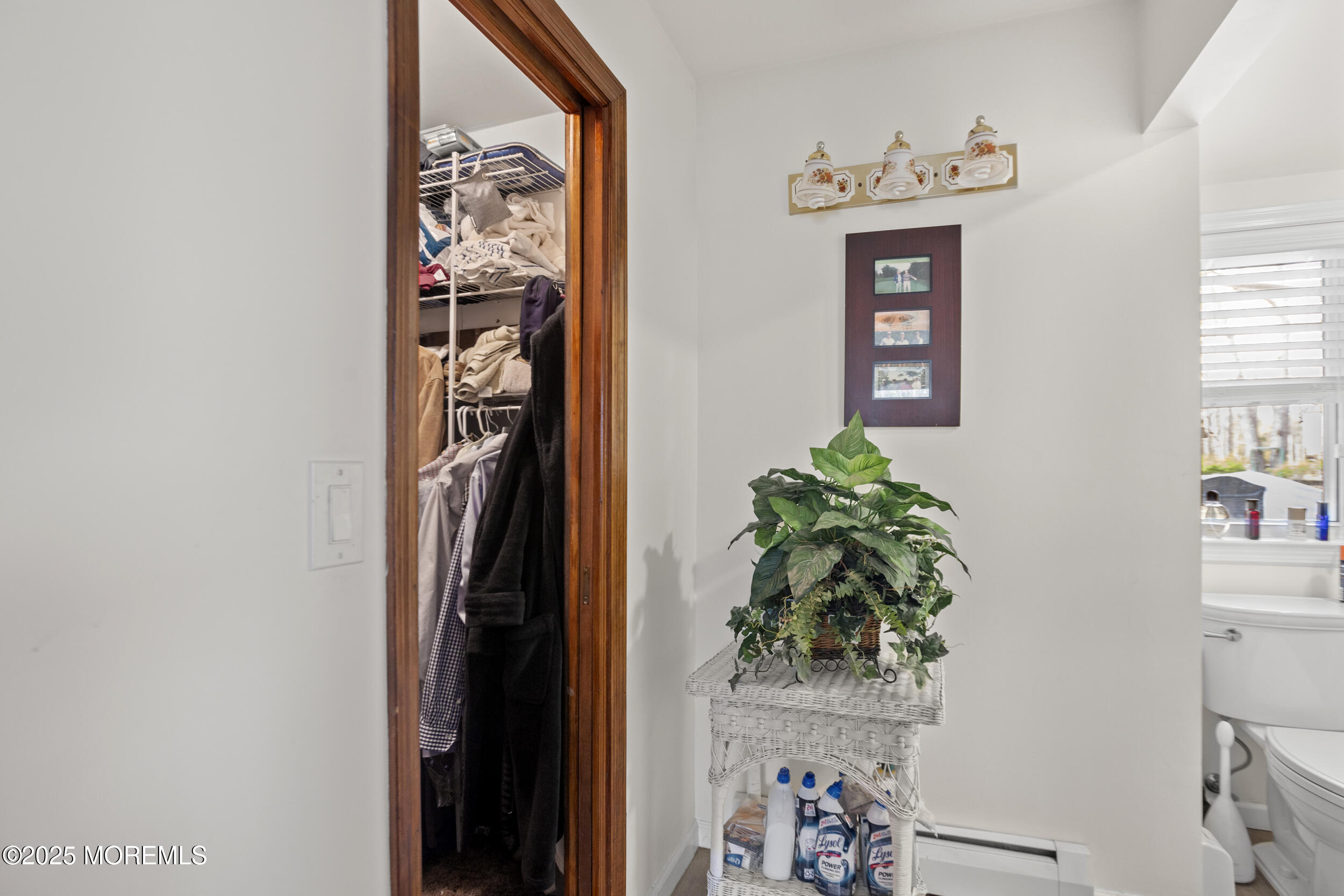 156 Sams Road Jackson, NJ 08527 - Photo 33 of 46 a view of a hallway with wooden floor and a potted plant