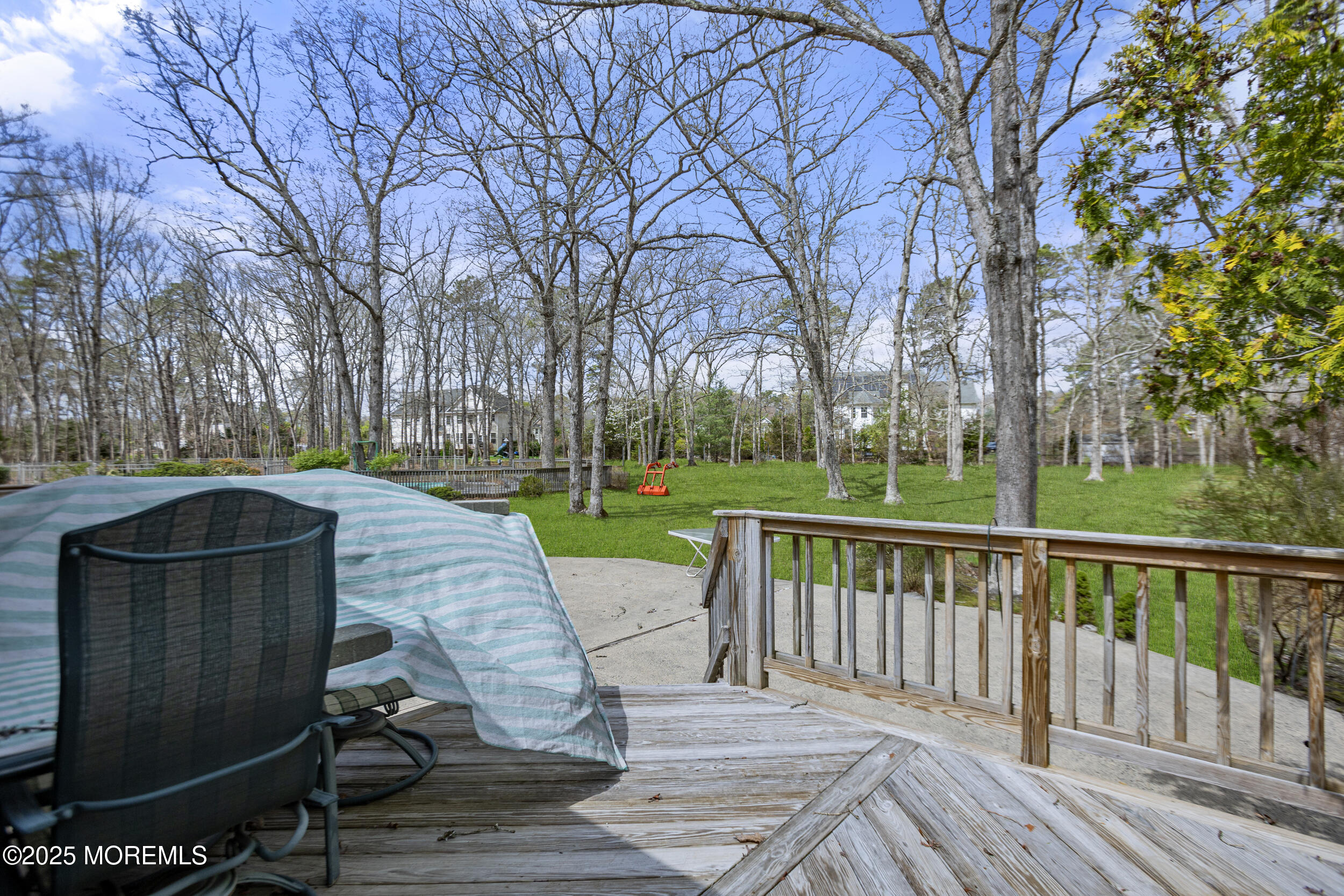 156 Sams Road Jackson, NJ 08527 - Photo 36 of 46 a view of a deck with a table and chairs a barbeque with wooden fence and floor