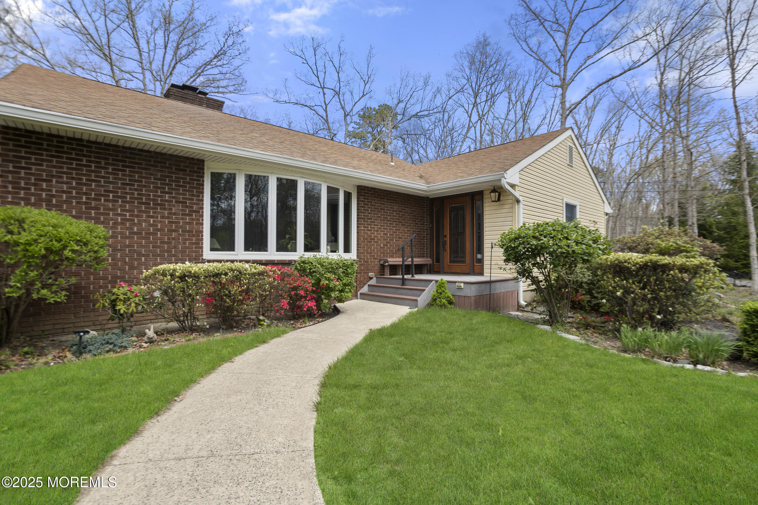 156 Sams Road Jackson, NJ 08527 - Photo 5 of 46 a front view of house with a garden and patio
