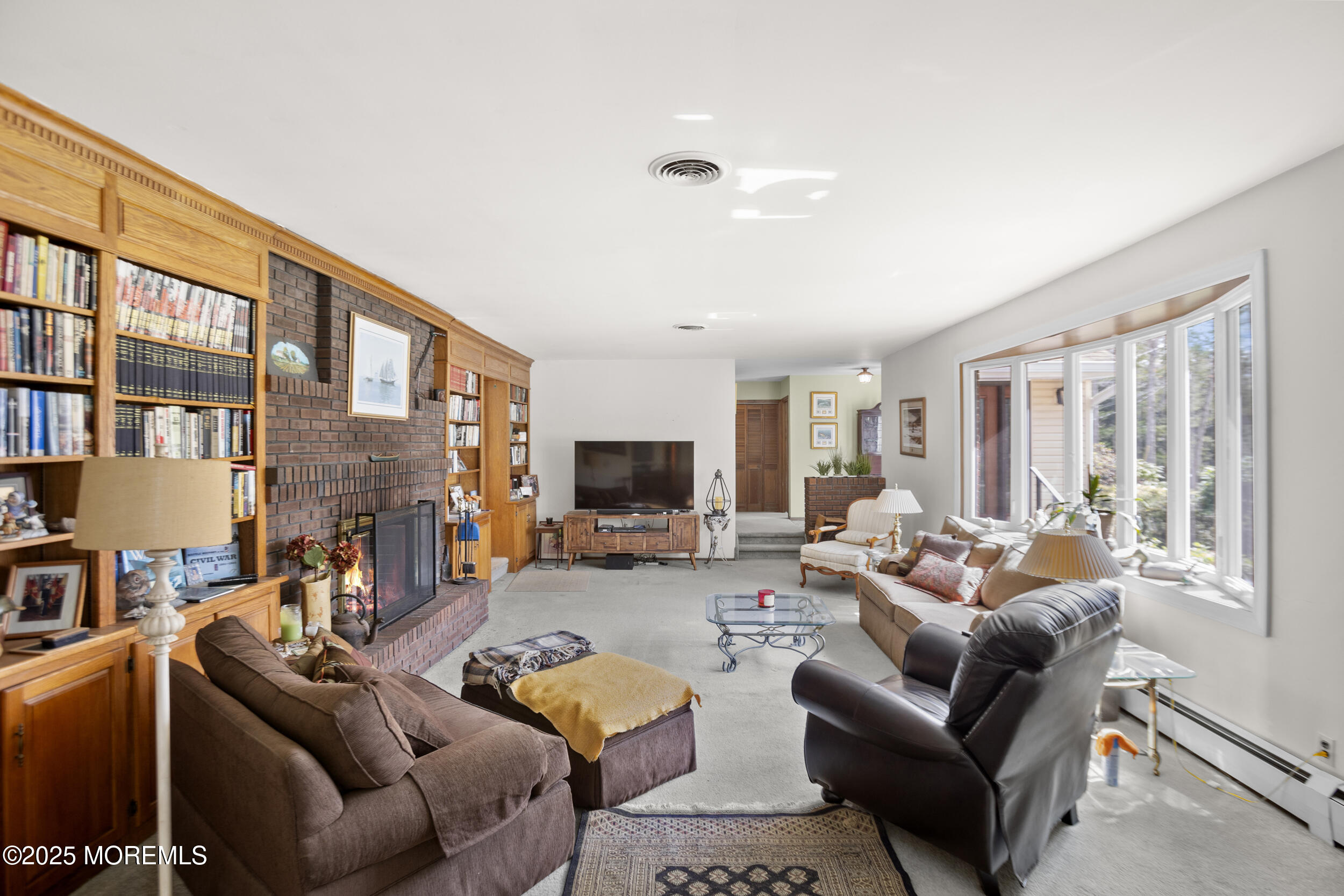 156 Sams Road Jackson, NJ 08527 - Photo 8 of 46 a living room with furniture fireplace and a large window