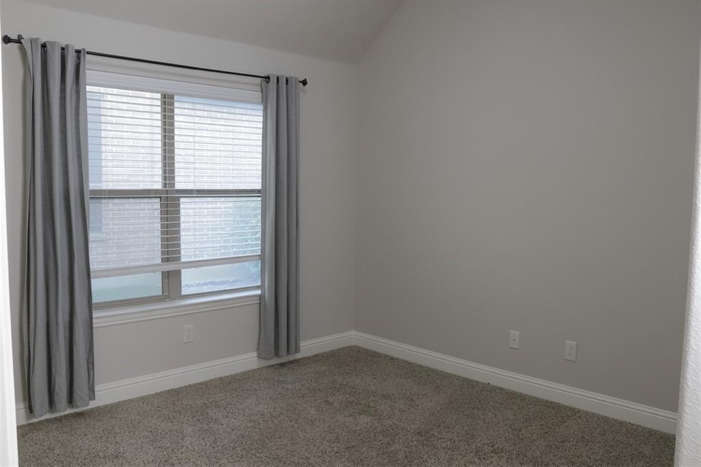 5709 Ridgepass Lane McKinney, TX 75071 - Photo 6 of 19 Window-filled room featuring neutral-toned walls, textured carpet flooring.