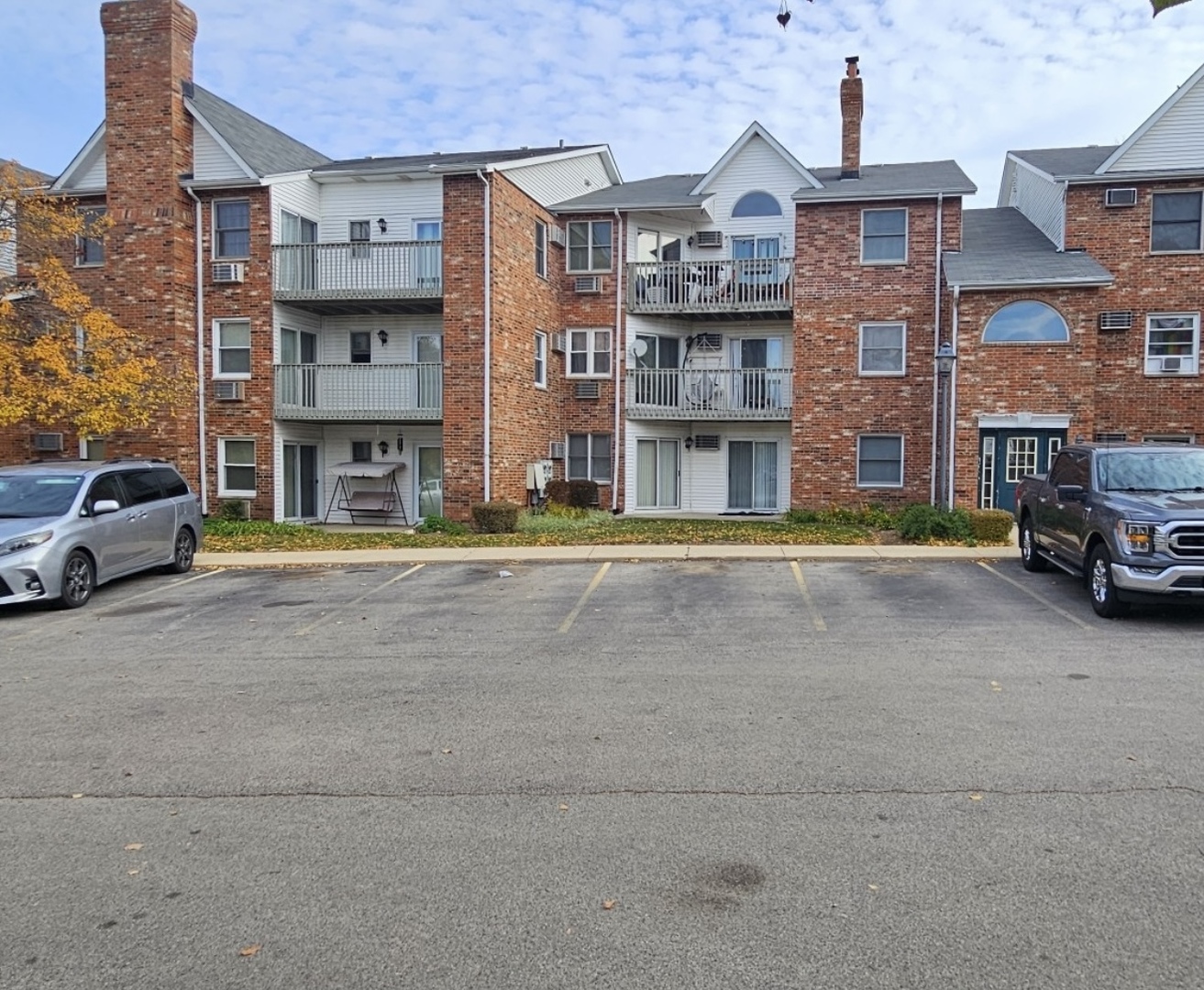 4304 West Shamrock Lane, Unit 1A McHenry, IL 60050 - Photo 1 of 20 a view of multiple houses with a street