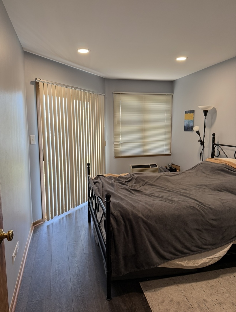 4304 West Shamrock Lane, Unit 1A McHenry, IL 60050 - Photo 11 of 20 a bedroom with a bed and a large window